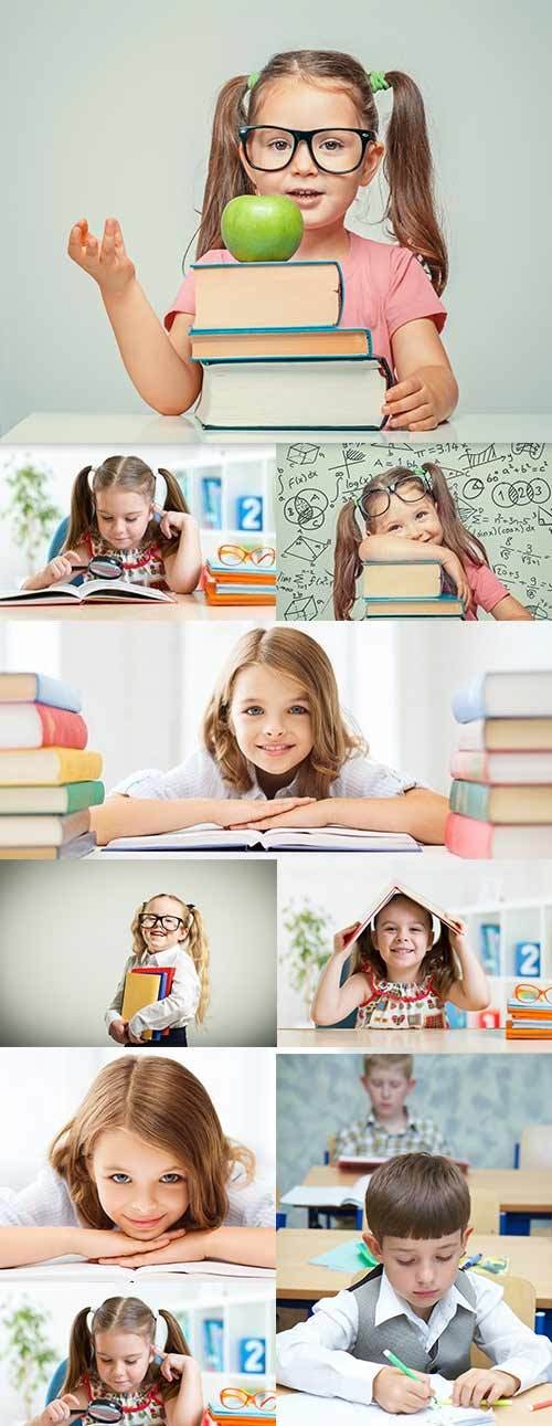 Preschool education happy children behind textbooks