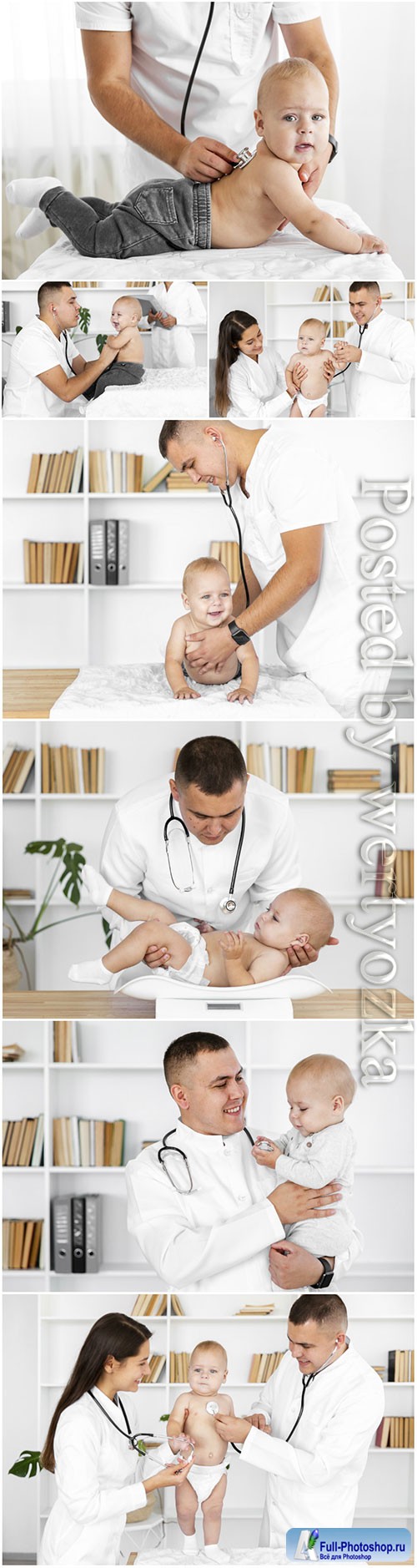 Doctor hands listening little baby stock photo